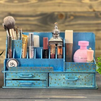 A close-up shot of the laser-etched "Origins" logo on the side of the wooden organizer.