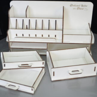 A top-down view of the "Origins" white makeup organizer, showing the various compartments filled with different makeup products.