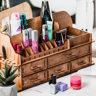 A flat lay image of the organizer on a clean surface with some cosmetic products scattered around it.