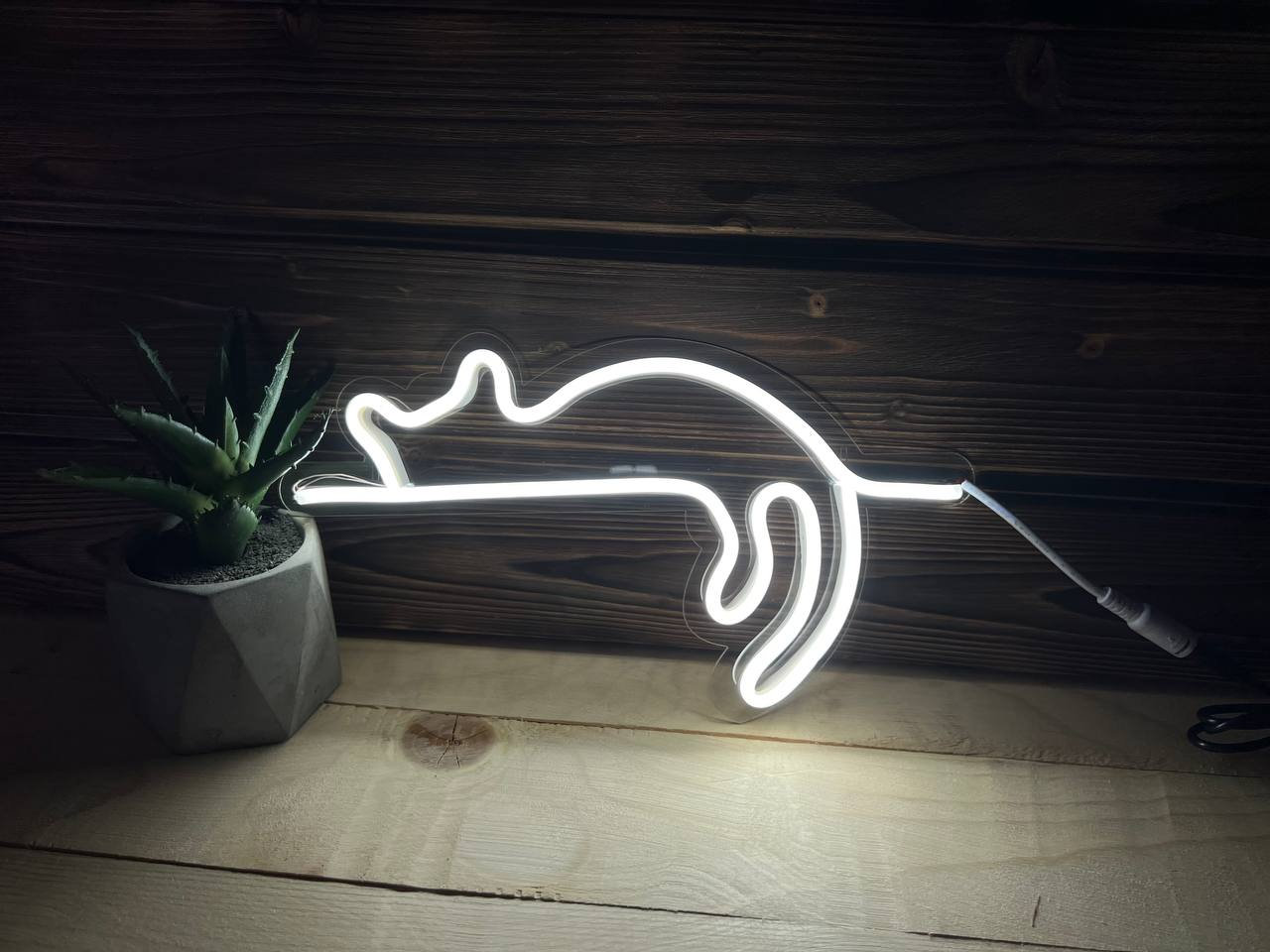 The nightlight plugged into a portable power bank on a camping table.