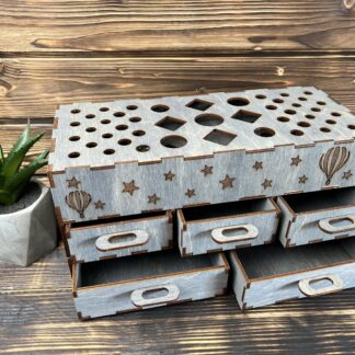 A photo of a hand placing a brush into one of the compartments.