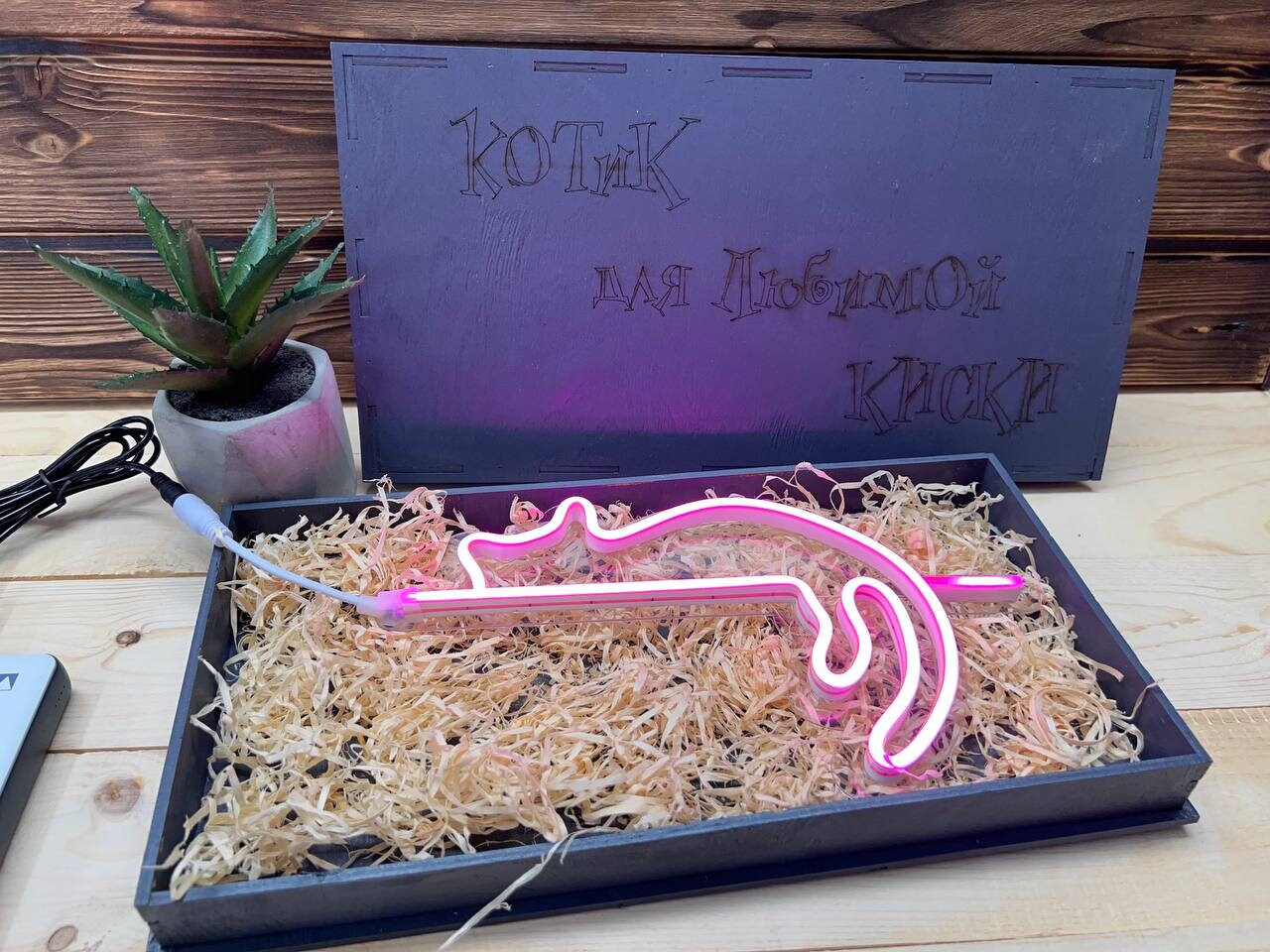 The nightlight plugged into a wall adapter in a bedroom.