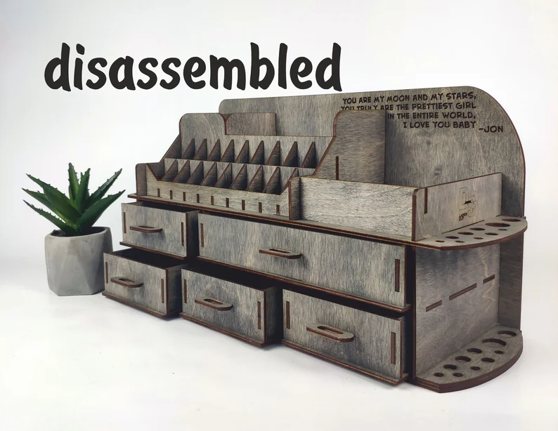 A photo showing a hand picking up one of the wooden pieces, ready for assembly.