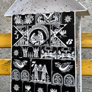 A close-up of a small decorative item placed in one of the compartments.