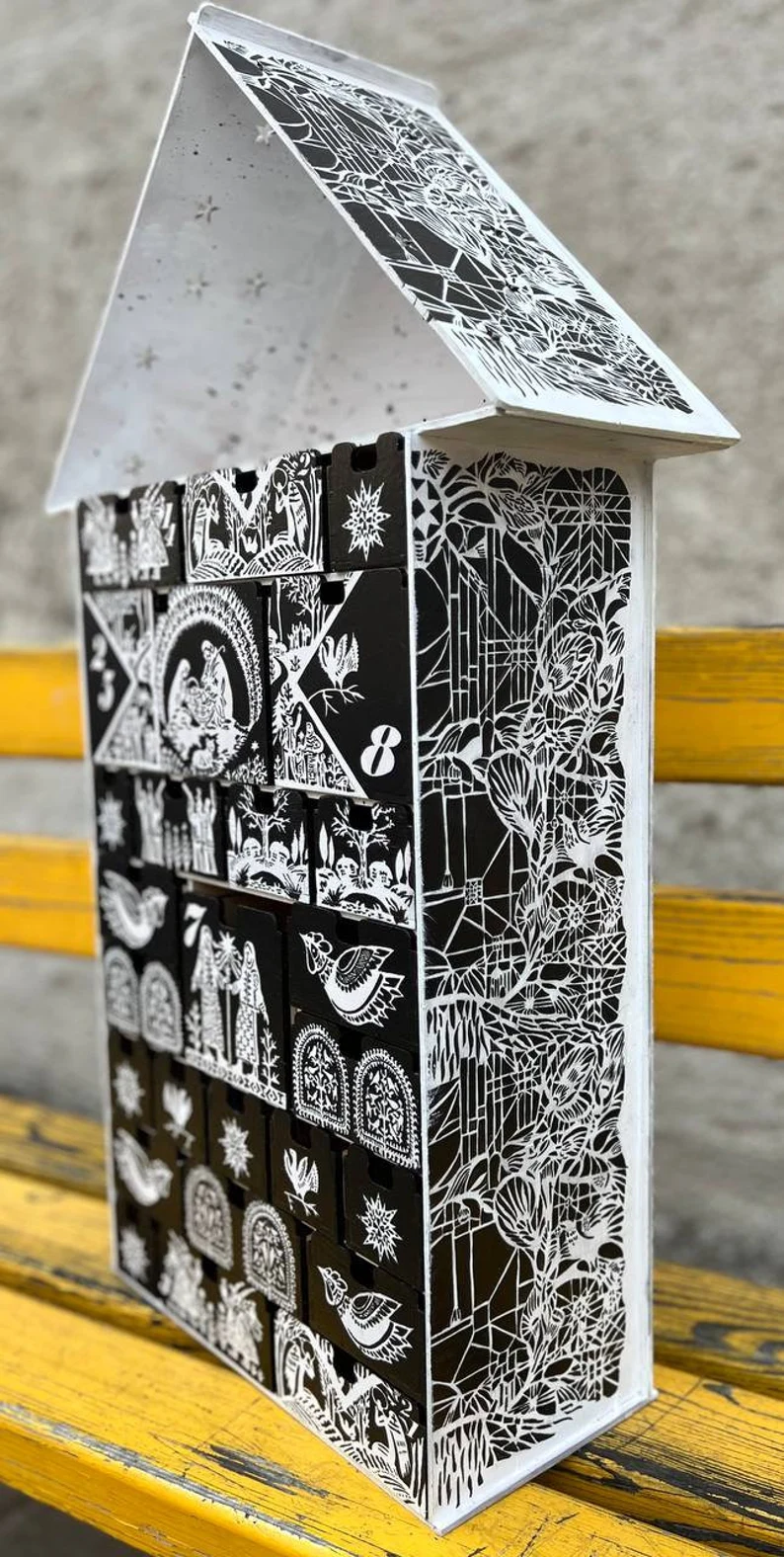 A close-up shot of the different compartments of the organizer, showcasing the smooth wood and its clean lines.