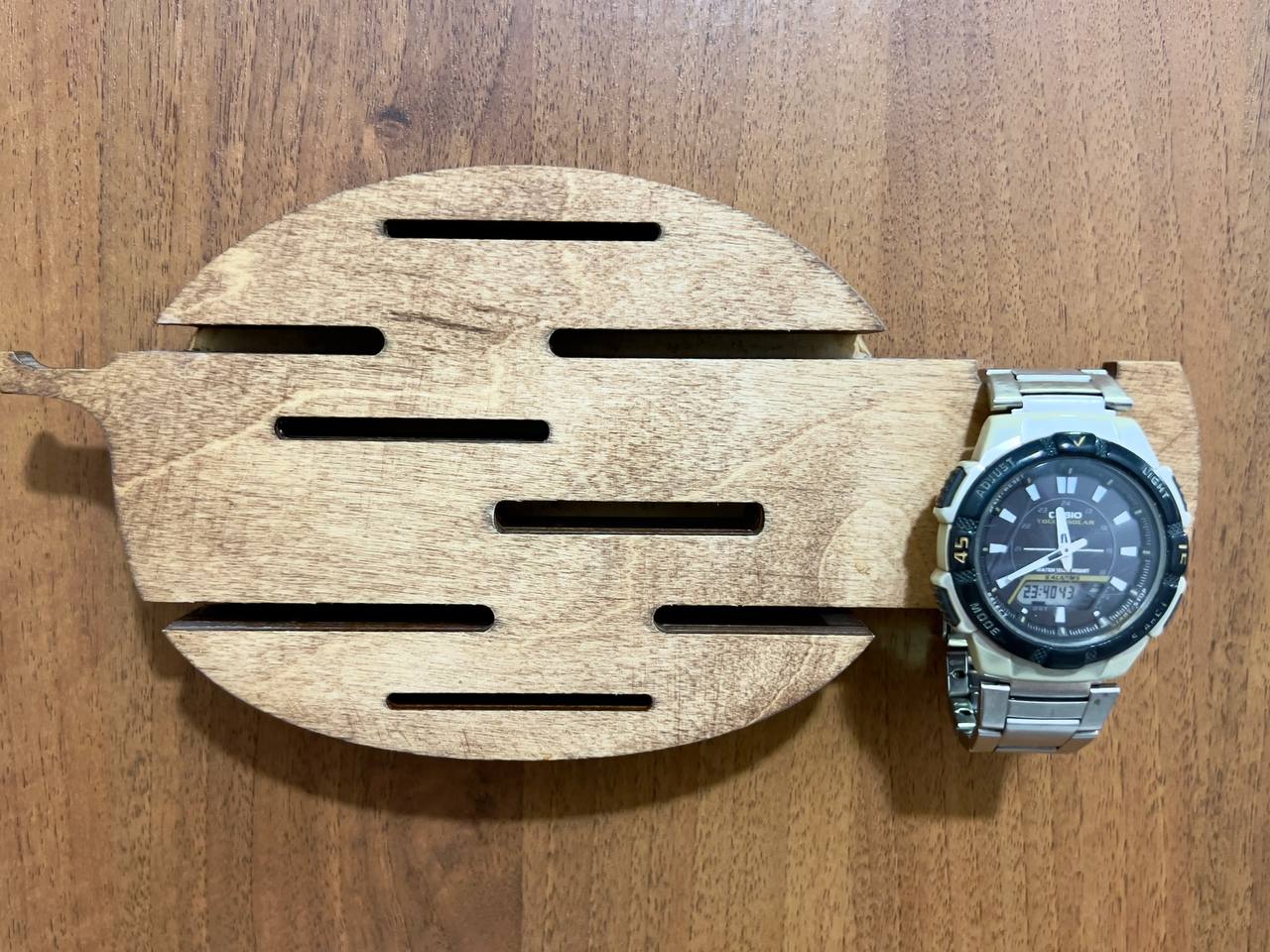 The key holder placed in a styled setting, such as above a console table with a plant or a small vase.