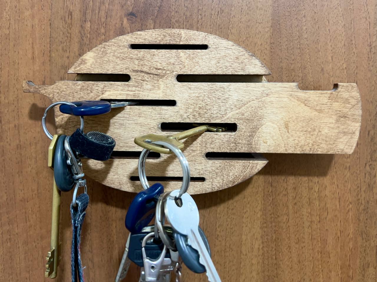 A close-up of the hooks on the underside of the key holder, showing their sturdy construction.