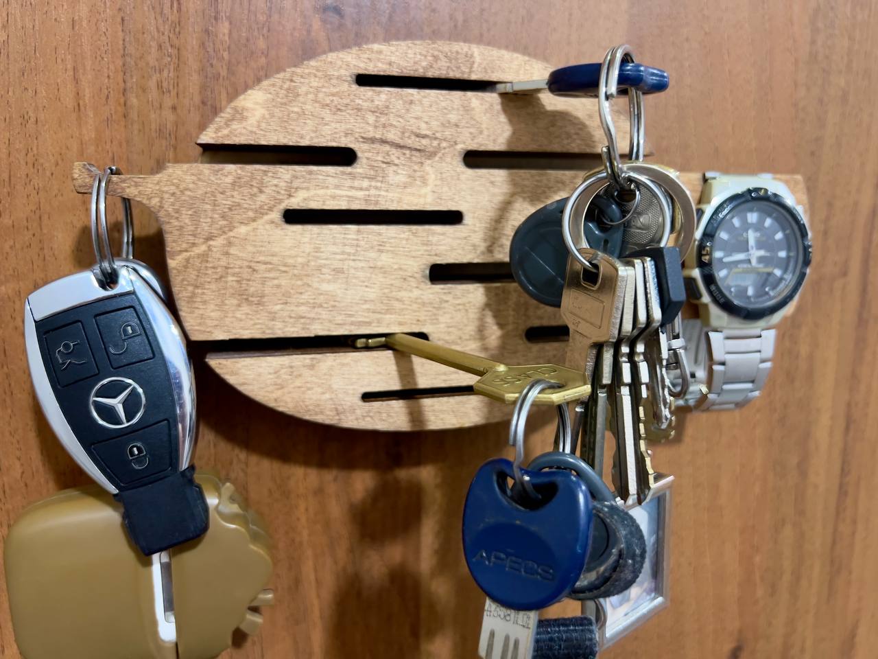 Close-up shot of the "All-Seeing Eye" design etched into the wooden key holder, highlighting the detailed laser work.