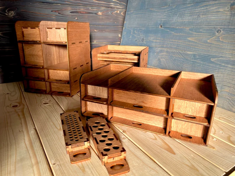 A top-down view of the modular wooden organizer, showing the various compartments filled with a variety of art supplies, such as paintbrushes, colored pencils, and tubes of paint.