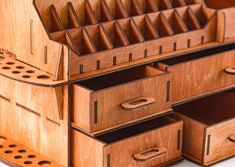 A photo of a hand placing a lipstick into one of the compartments, demonstrating its ease of use.