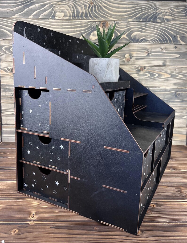 A close-up of a hand taking a brush from one of the compartments.