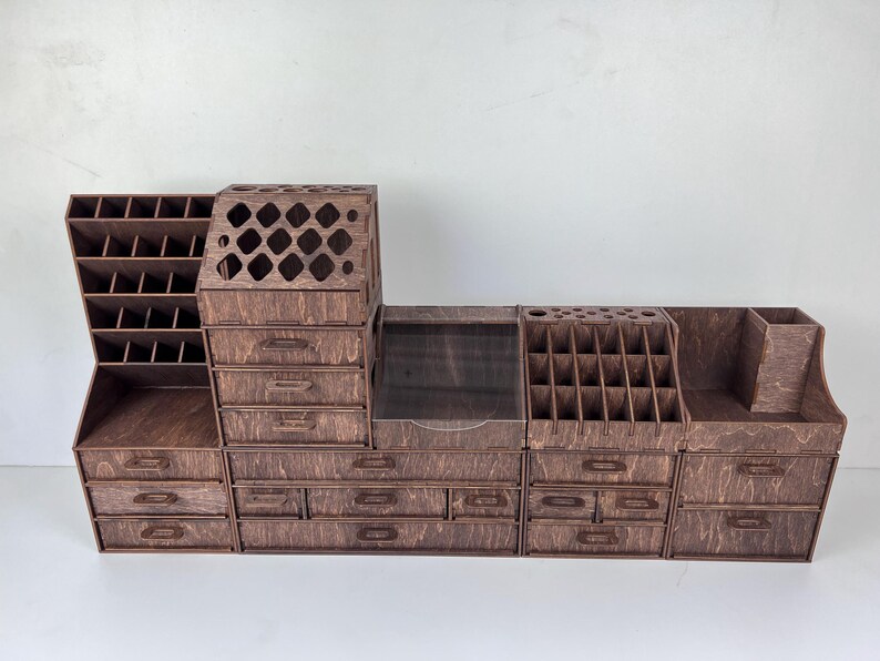 A top-down view of the modular makeup organizer showing the various compartments and their ability to be rearranged.