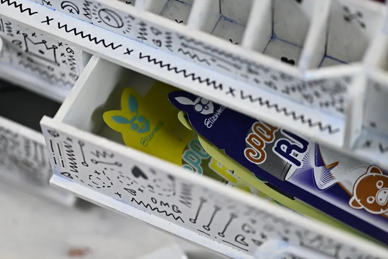 A side view of the organizer, showing the different compartment sizes and the smooth, polished exclusive finish.