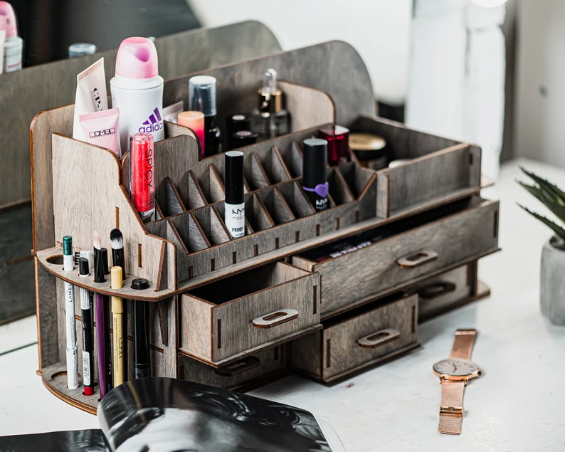 A side view of the organizer, showing the different compartment sizes and the smooth, polished wood surface.