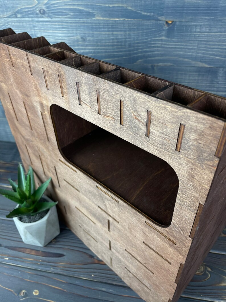 The wooden organizer on a countertop, surrounded by other cosmetics, showcasing its use.