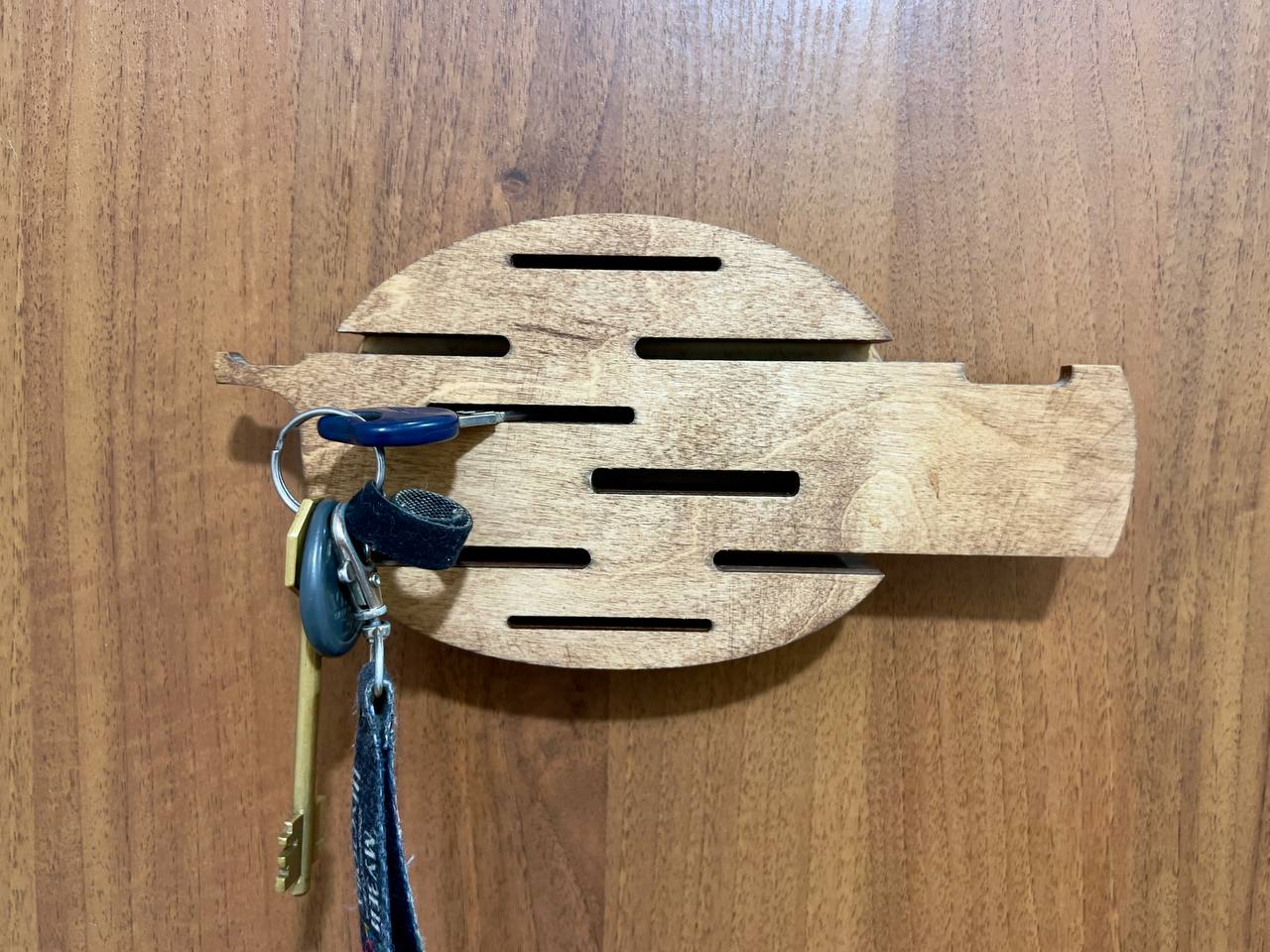 A flat lay image of the key holder, showcasing its overall design and texture on a light-colored background.