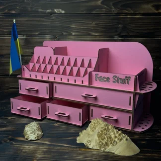 A flat lay image of the pink organizer on a clean surface with some cosmetic products scattered around it.