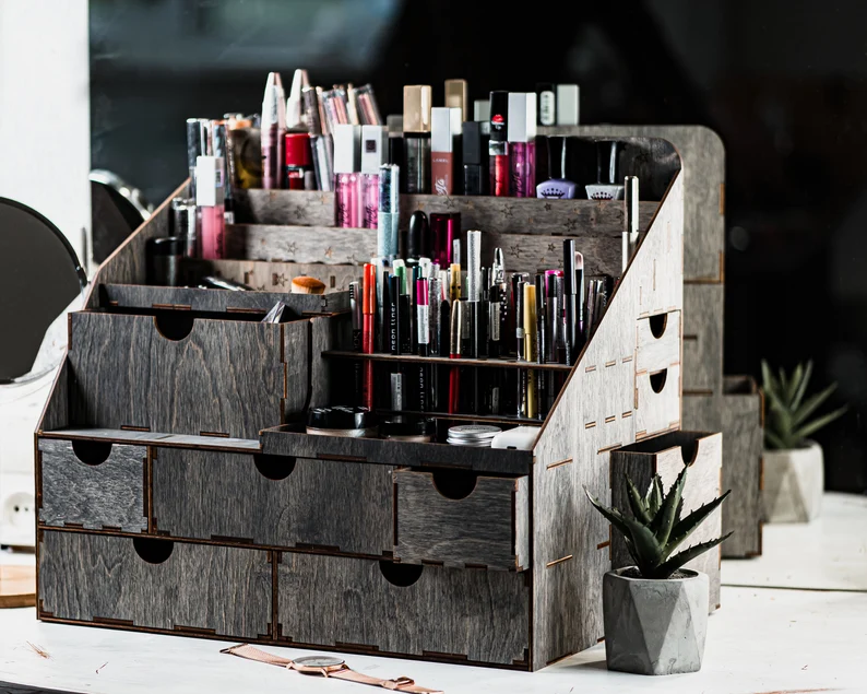 A top-down view of the organizer showing its numerous compartments filled with a variety of beauty products.