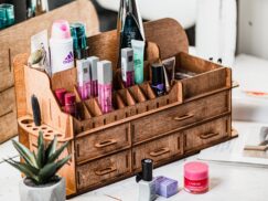 A flat lay image of the organizer on a clean surface with some cosmetic products scattered around it.
