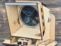 A shot of a user soldering a circuit board, with the fume extractor clearly absorbing the smoke.