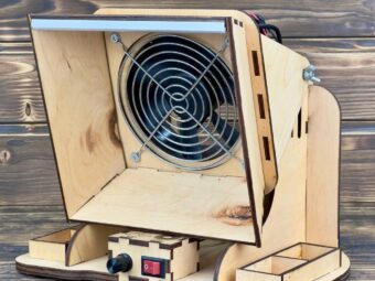 A shot of a user soldering a circuit board, with the fume extractor clearly absorbing the smoke.