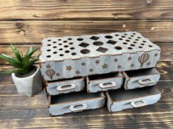 A photo of a hand placing a brush into one of the compartments.