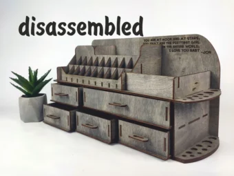 A photo showing a hand picking up one of the wooden pieces, ready for assembly.