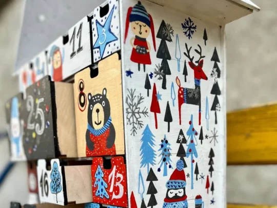 A close-up shot of several of the small, numbered drawers on the advent calendar, some of which are slightly open.
