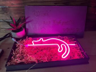 A photo of the nightlight in a hand, emphasizing its portability.